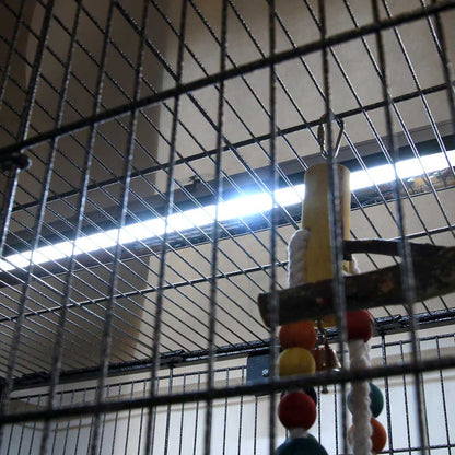 An Arcadia PureSun Midi UVB lamp mounted over a cage